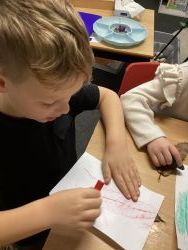 Child creating a leaf rubbing