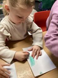 Child creating a leaf rubbing