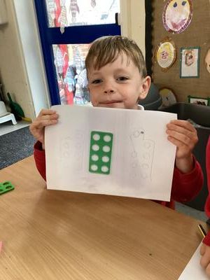 Child holding their work