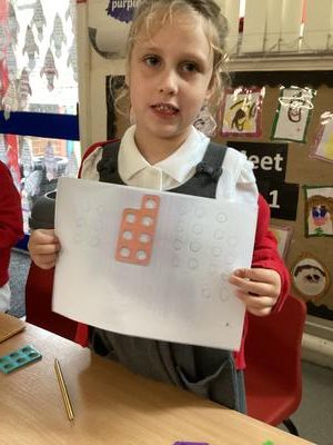 Child holding their work