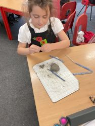 Child creating a Anglo-Saxon statue