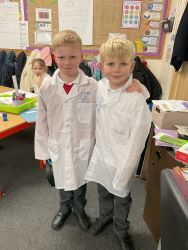 Children wearing lab coats