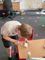 Child making tools out of soap