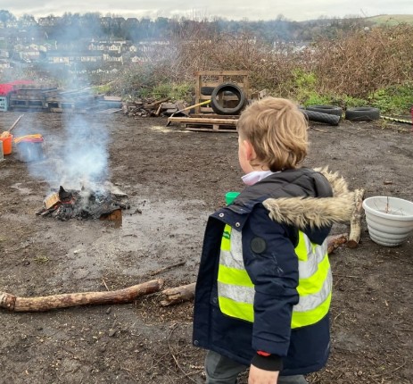 Child watching the smoke from the fire