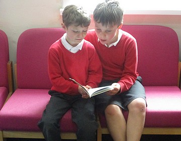 Photos of two children reading