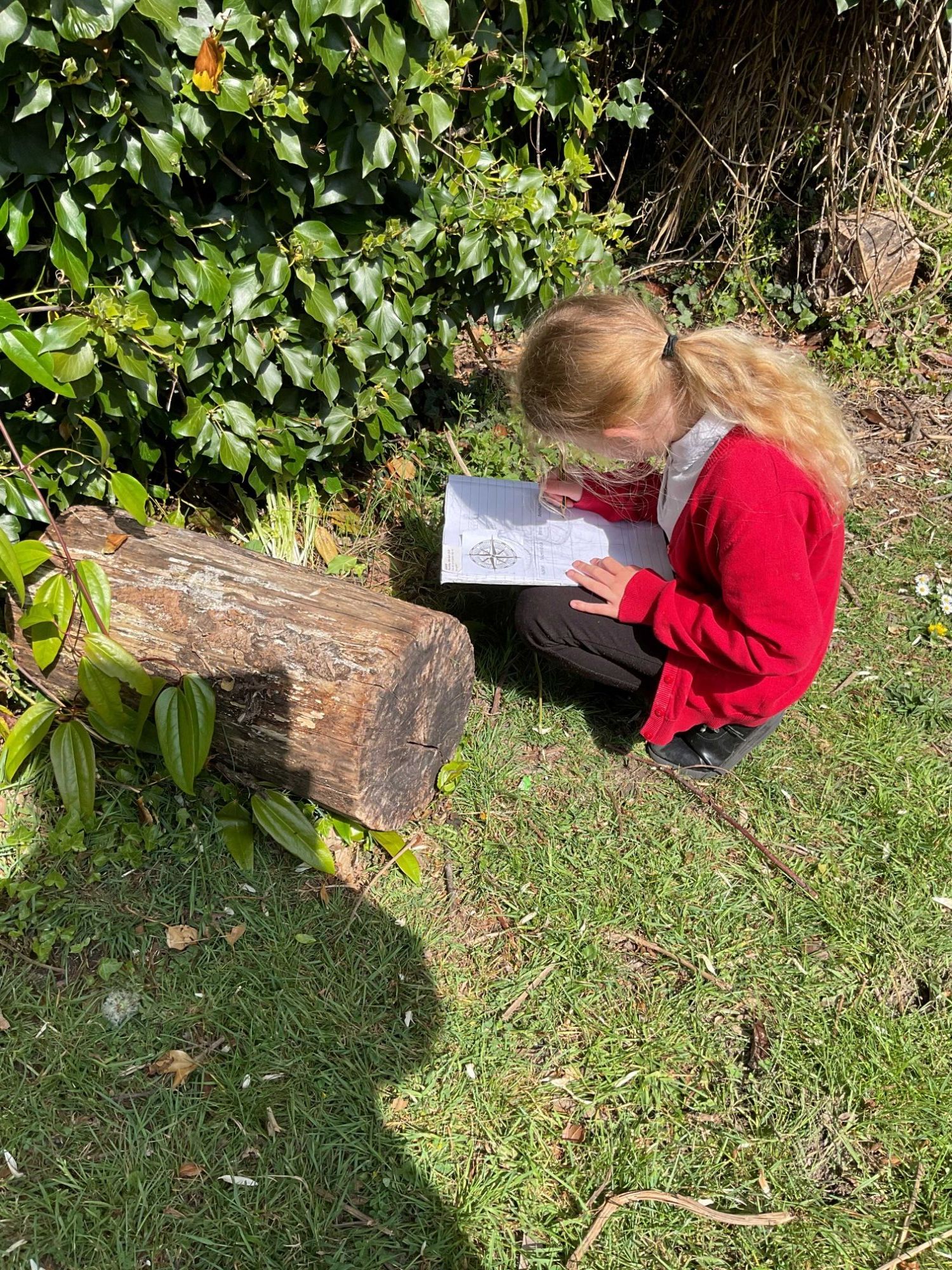 child crouching on ground outdoors