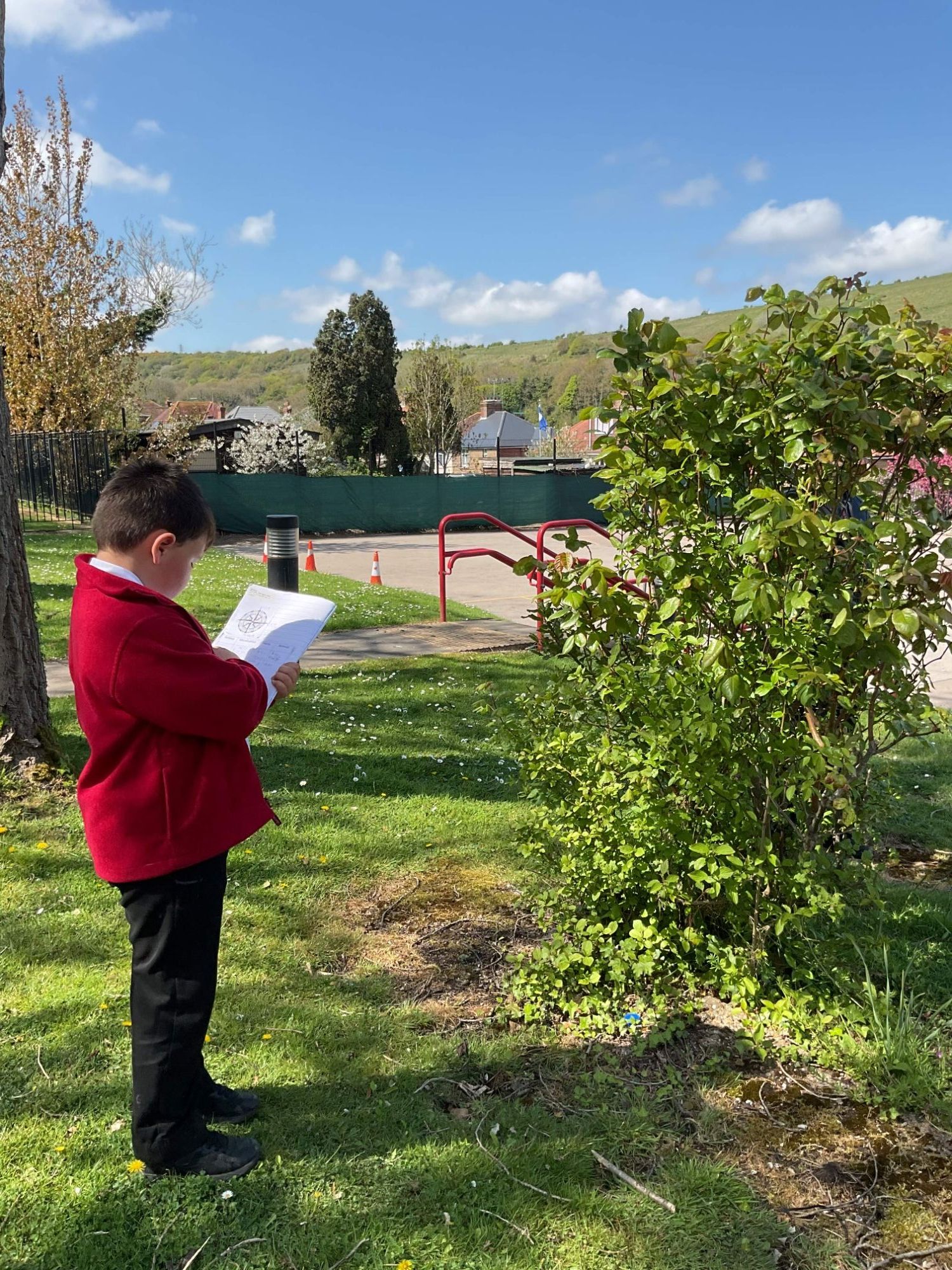 child writing in book outdoors